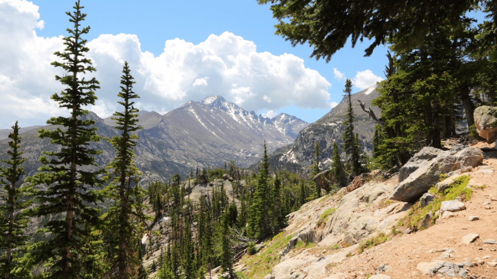 Hiker testing rain-ready Colorado outdoor gear on a mountain trail